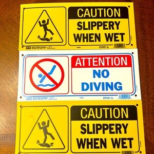 Two Caution Slippery When Wet Signs and One No Diving Sign